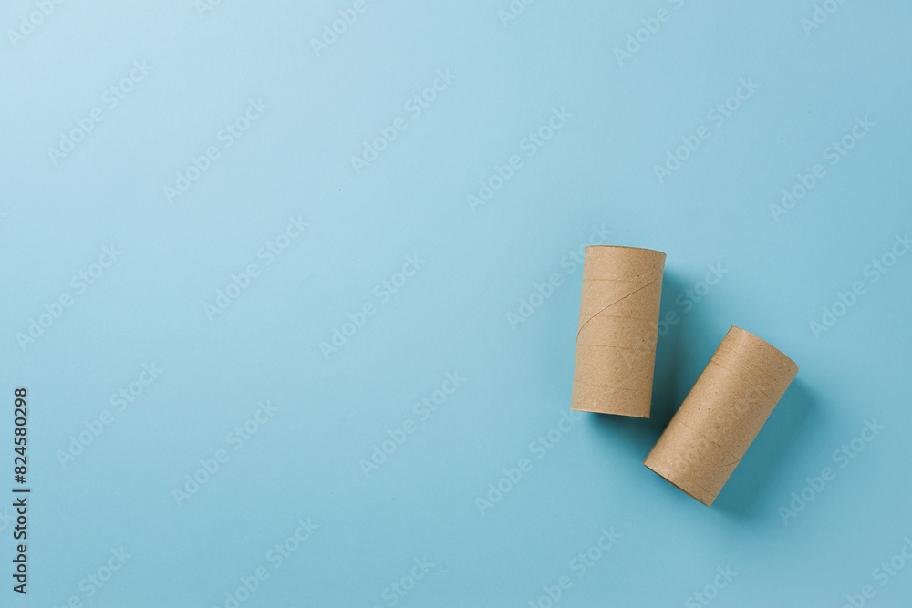 Top view of two empty toilet paper rolls on blue background Top view of two empty toilet paper rolls on blue background
