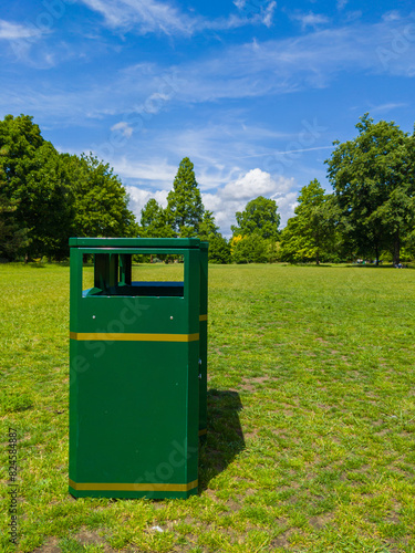 A bin at the middle of grass area in a park (Cardiff, Wales, United Kingdom)