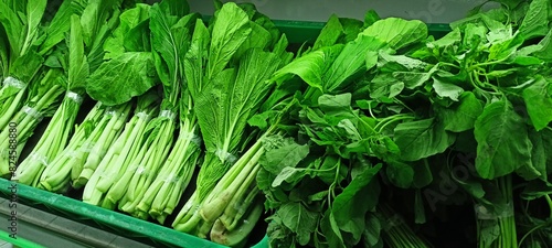 fresh vegetables on supermarket shelves photo