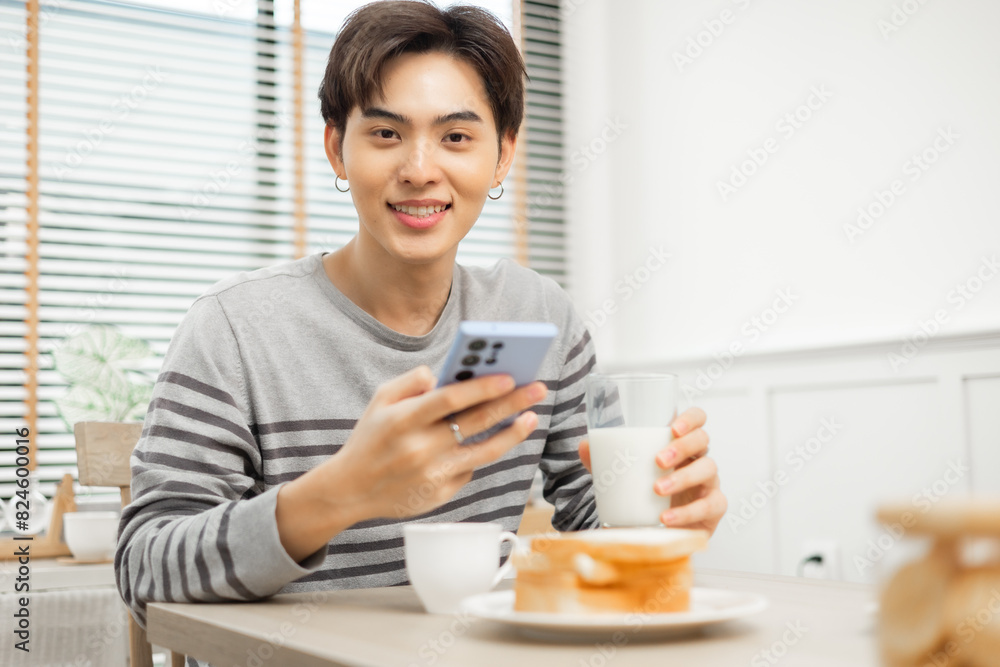 young father enjoying breakfast with milk in a warm, inviting kitchen.Asian family breakfast scene, parents a.e young father enjoying breakfast with milk in a warm, inviting kitchen.Asian family breakfast scene, parents a.e