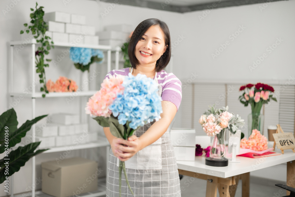 A couple of Asian entrepreneurs using their smartphones to sell flowers online. A couple of Asian entrepreneurs using their smartphones to sell flowers online.
