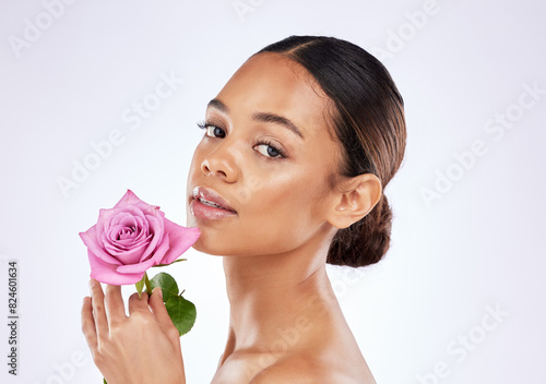 Skincare  portrait and girl with rose  flower and healthy dermatology on studio background. Floral  cosmetics and woman with self care for natural glow on face or blossom with beauty in spring