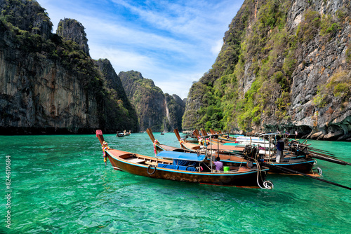 View of Pi Leh lagoon (also known as Green Lagoon) at Ko Phi Phi islands, Thailand.Tourist long tail boat Landed on a peaceful beach, clear water, surrounded by hills of Koh Phi Phi.Thailand