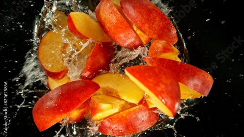 Freeze Motion of Flying Peaches into Water, Black Background.