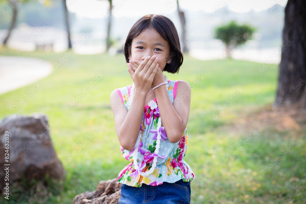 Fototapeta premium Cute little girl on the meadow in summer day