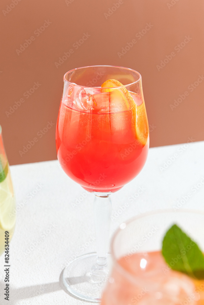 Refreshing Aperol Spritz Cocktail with Orange Garnish in Wine Glass Against Warm Background