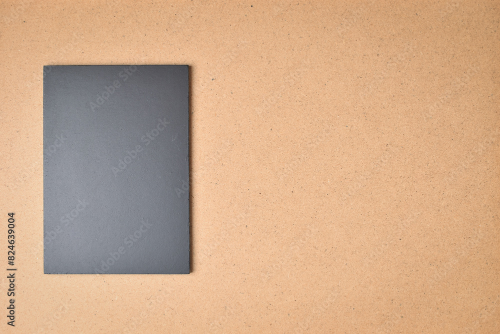 Fototapeta premium blank black notebook on brown wood texture background