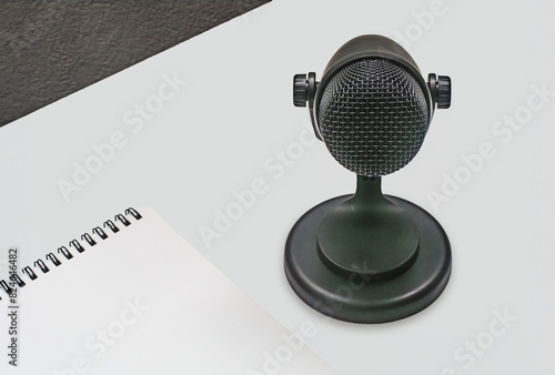 background with microphone and notepad on table photo
