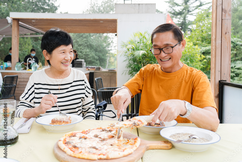 Happy Asian Senior mature married couple Enjoying Healthy Lunch Outdoors on a open air Sunny Terrace. on vacation in a sunny summer day Happy Asian Senior mature married couple Enjoying Healthy Lunch Outdoors on a open air Sunny Terrace. on vacation in a sunny summer day