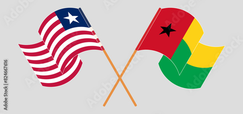 Crossed and waving flags of Liberia and Guinea-Bissau