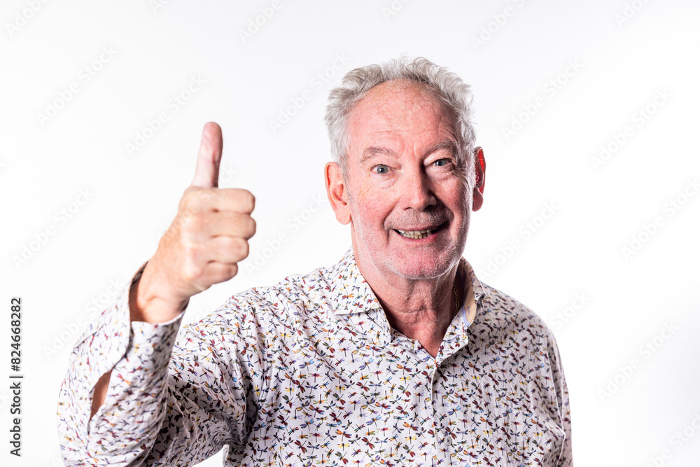 A cheerful senior man is showing a thumbsup gesture, radiating positivity and approval with a friendly smile A cheerful senior man is showing a thumbsup gesture, radiating positivity and approval with a friendly smile