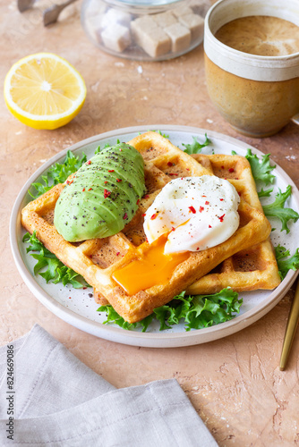 Belgian waffles with avocado and poached egg. Healthy eating. Vegetarian food. Breakfast.