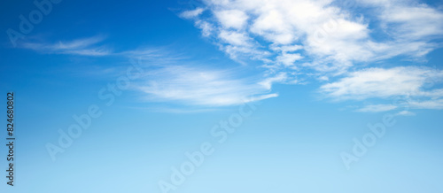 A spring, summer blue sky background with white fluffy clouds in a warm climate.