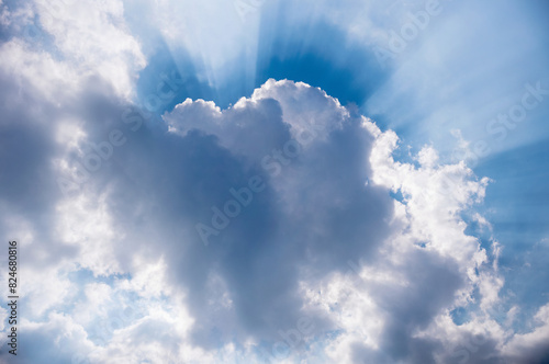 A spring, summer blue sky background with white fluffy clouds in a warm climate.