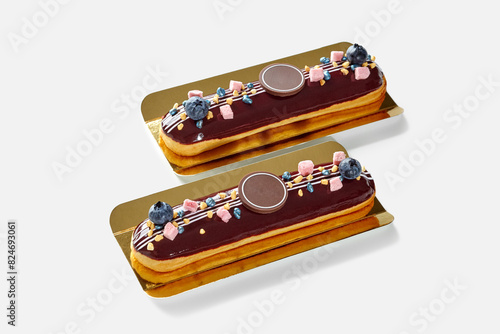 Delicious chocolate glazed eclairs with fresh blueberries and sweets