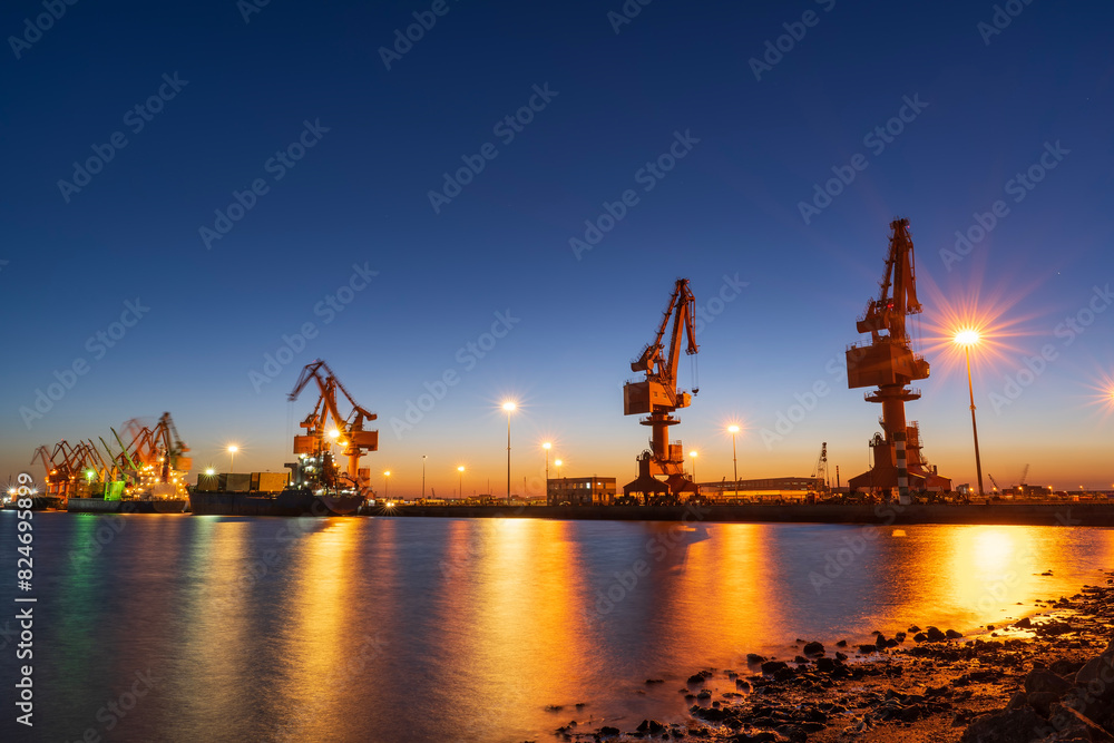 Gantry crane and cargo ship in the evening Gantry crane and cargo ship in the evening