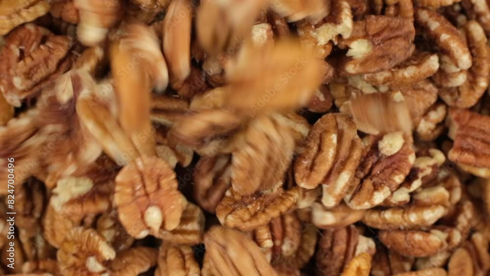 Pecan nuts falling down in bowl, top view. Healthy food concept Pecan nuts falling down in bowl, top view. Healthy food concept