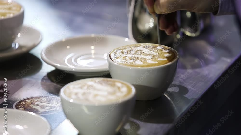Close-up of barista hands pouring milk for prepare cup of coffee at coffee shop and restaurant, bar or pub. Latte art, coffee preparation, lifestyle and service. Close-up of barista hands pouring milk for prepare cup of coffee at coffee shop and restaurant, bar or pub. Latte art, coffee preparation, lifestyle and service.