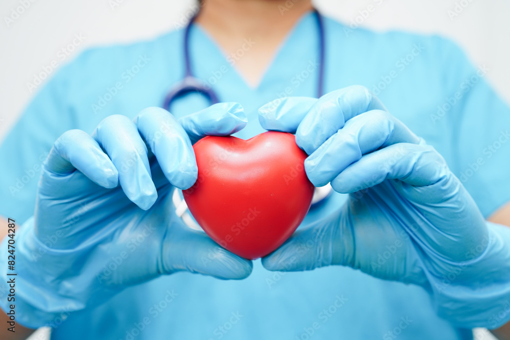 Asian woman doctor holding red heart for health in hospital. Asian woman doctor holding red heart for health in hospital.