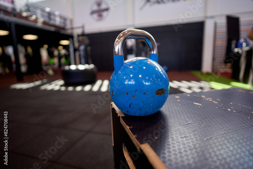 Blue kettle bell on a plyo box in the gym, essential equipment for cross fit and strength training workouts.