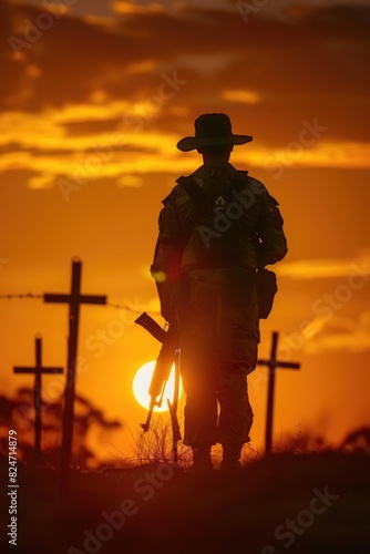 A soldier standing in front of a cross at sunset. Ideal for military or memorial concepts