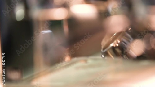Barista making coffee with manual presses ground coffee using tamper at the coffee shop. Close-up of hands. Coffee aroma and the warm shop atmosphere photo