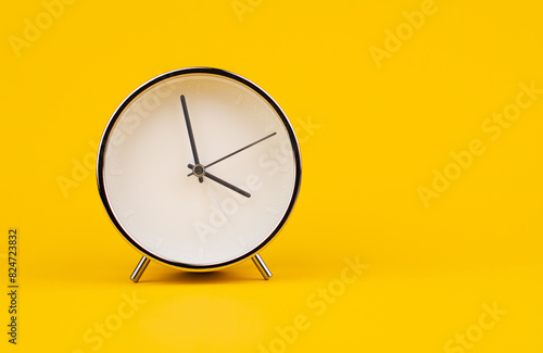 Time and work, the clock stops, the minute hand stops moving, a photo of a clock on a yellow background.