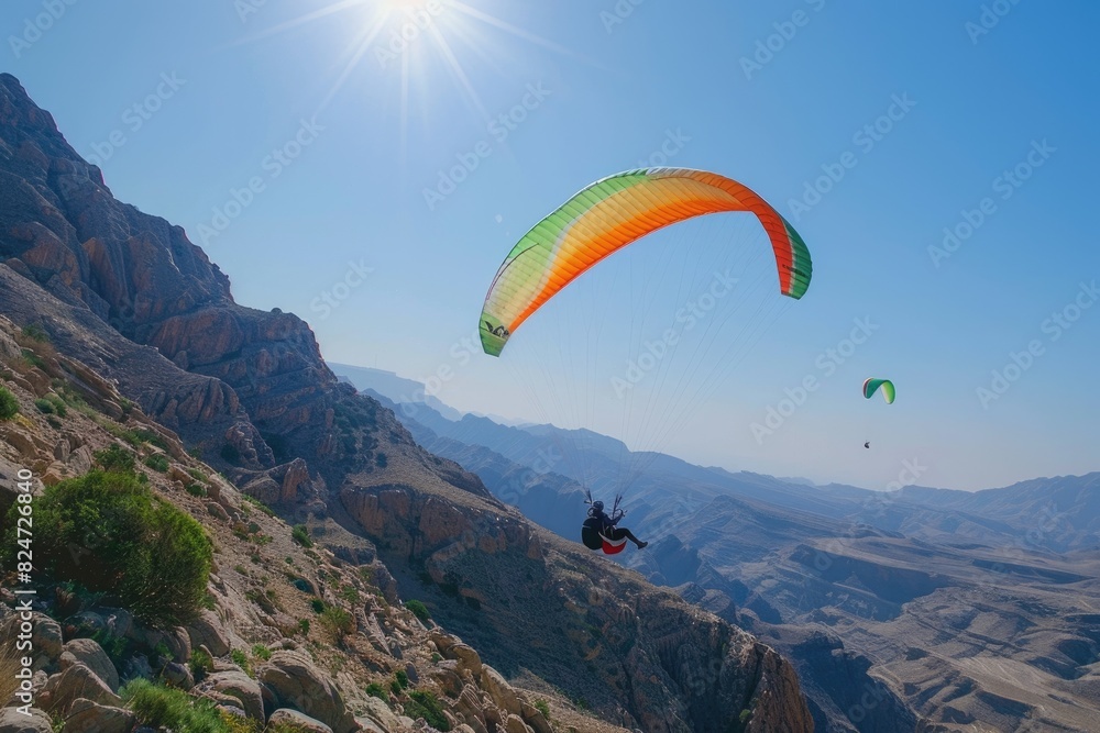 Paragliders flying in the valley Paragliders flying in the valley