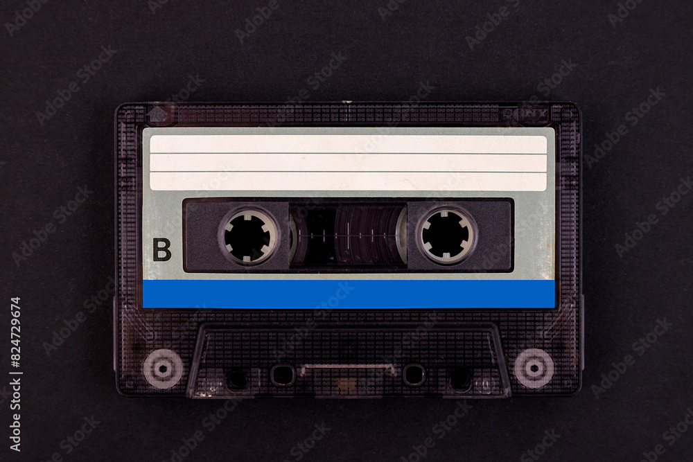 Fototapeta premium Retro audio cassette tape from the 80s on a black background.