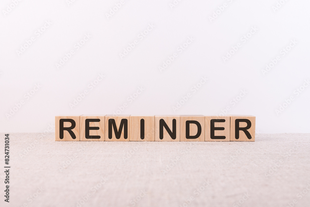REMINDER word made of building blocks on a white background
