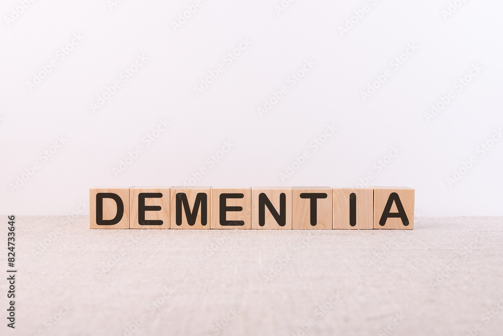 Dementia word concept written on wooden cubes on a light table and a light background Dementia word concept written on wooden cubes on a light table and a light background