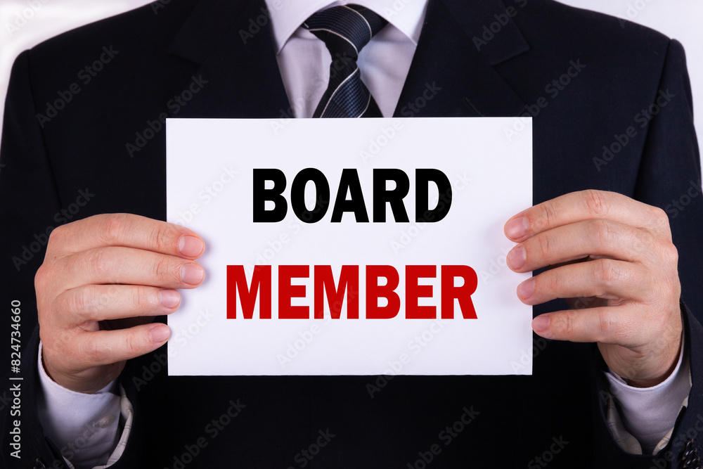 Businessman holding a card with text board member Businessman holding a card with text board member