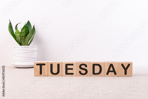 Photos The word Tuesday on wooden cubes. Weekday concept.