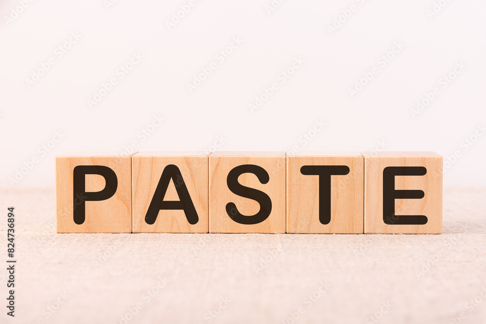 Word PASTE made with wood building blocks on a light background Word PASTE made with wood building blocks on a light background