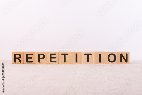 Quadro em tela Word REPETITION made with wood building blocks