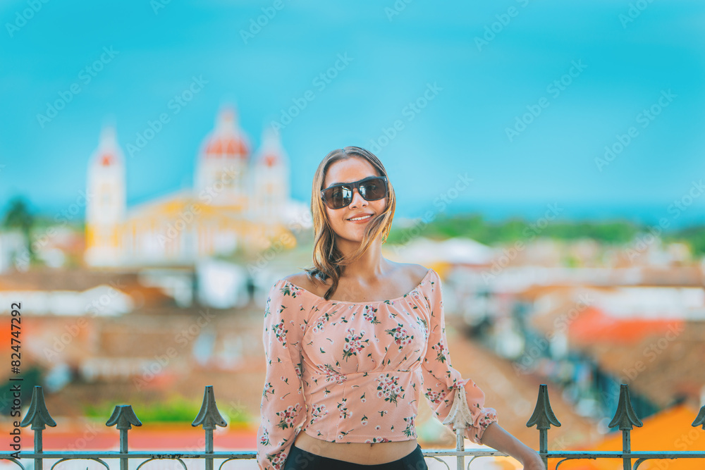 Happy young woman on vacation in Granada city, Nicaragua. Portrait of a beautiful tourist girl with a view of the cathedral in Granada
