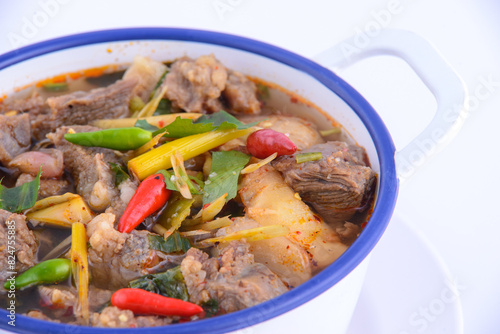 Thai favorite food. Spicy chicken soup (Tom Yum Gai Baan) in the white bowl.