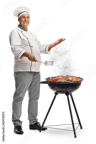Mature male chef grilling meat on a bbq