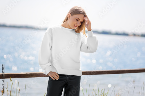 Mockup of white sweatshirt on blonde girl on background of river, quay, pullover front view.