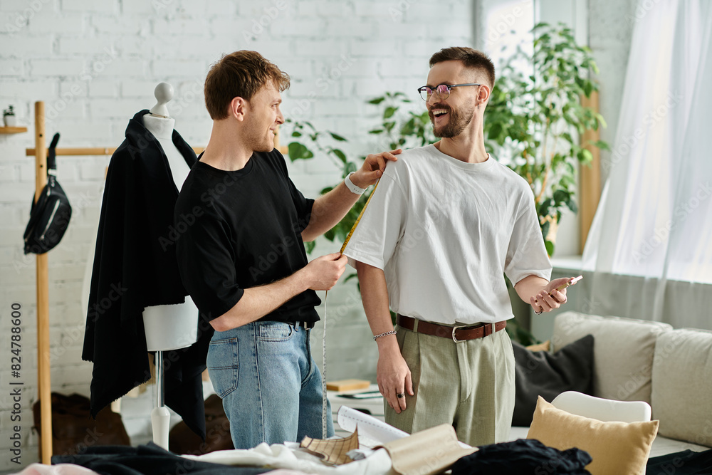 Obraz premium Two men in a designer workshop, working on stylish attire together.