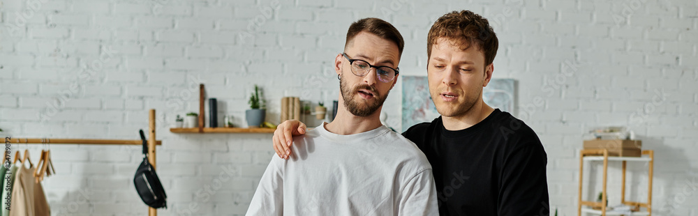 Two men, a gay couple, collaborate in a designer workshop to create trendy attire. Two men, a gay couple, collaborate in a designer workshop to create trendy attire.