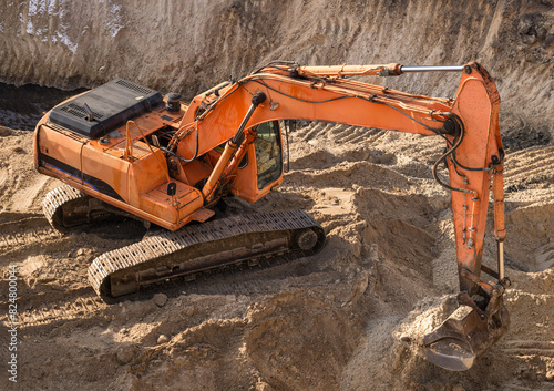 Excavator digging a pit at a construction site