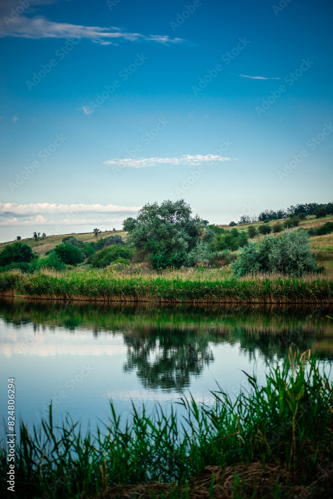 Fototapeta premium Summer river at morning . Forest on anothe beach. Fog on the water . Green forest . Reflections on the water . Sky over the lake . Trees on beach