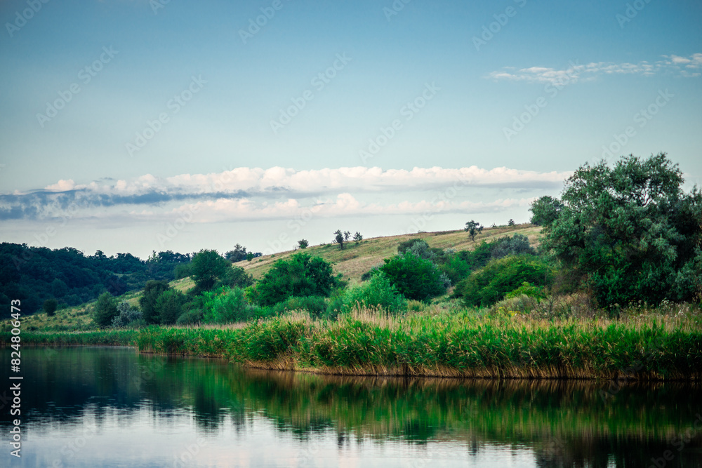 Obraz premium Summer river at morning . Forest on anothe beach. Fog on the water . Green forest . Reflections on the water . Sky over the lake . Trees on beach