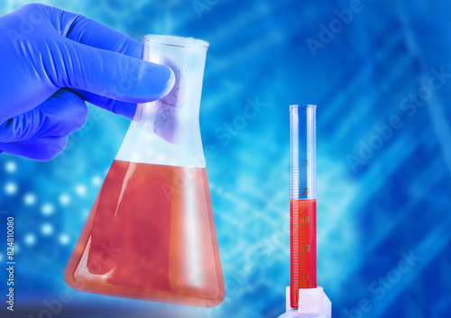 Laboratory flask in hands in blue gloves and a beaker with red liquid on a blue background