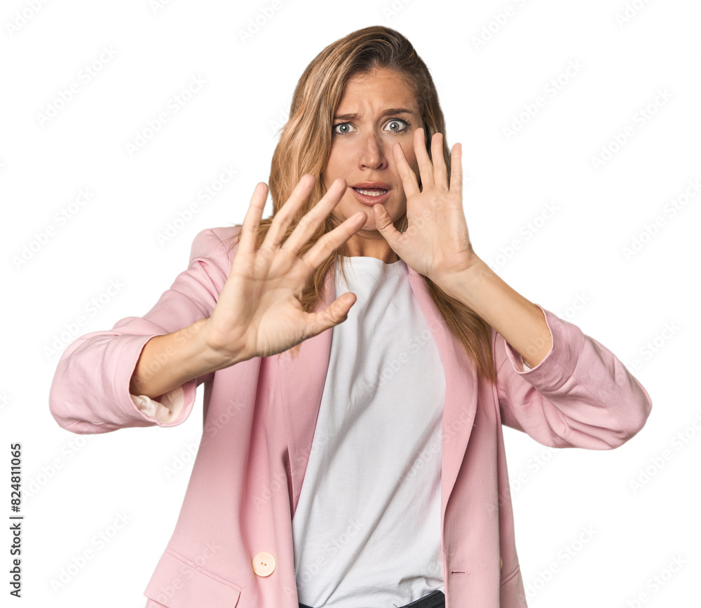 Young blonde in stylish pink suit being shocked due to an imminent danger Young blonde in stylish pink suit being shocked due to an imminent danger