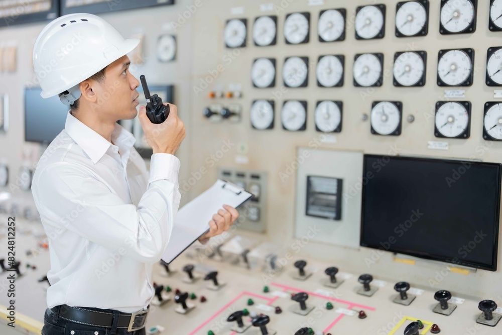 Asian male engineer working on the complex work of a power plant and ...
