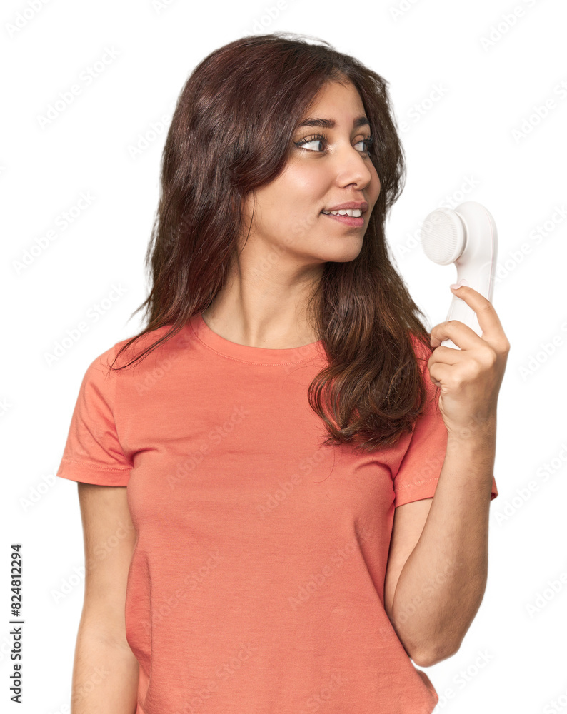Middle Eastern woman with facial cleanser looks aside smiling, cheerful and pleasant. Middle Eastern woman with facial cleanser looks aside smiling, cheerful and pleasant.