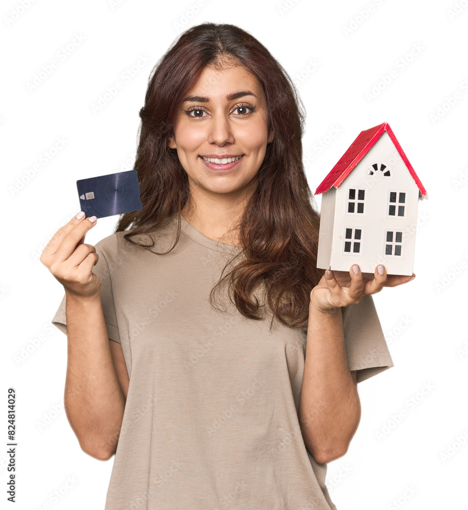 Young Middle Eastern woman with credit card and a house Young Middle Eastern woman with credit card and a house