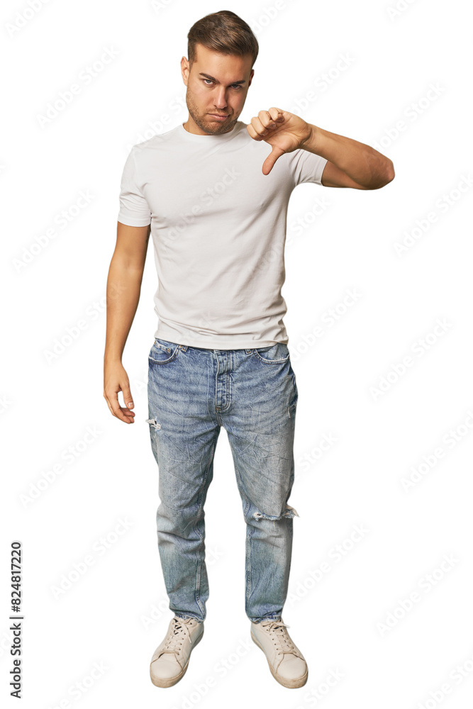 Fototapeta premium Full body portrait of a man in studio showing thumb down, disappointment concept.
